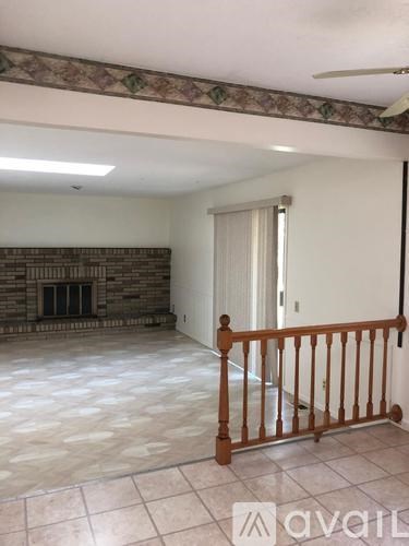 A room with a fireplace and a tiled floor.