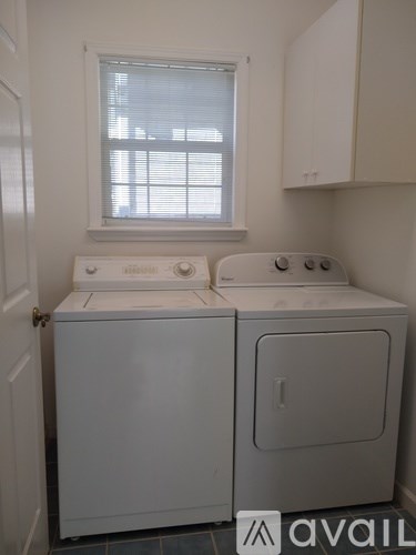 A white washer and dryer in a small laundry room.