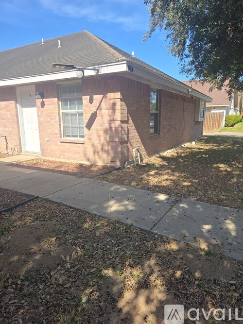 A house with a white door and a brick wall.