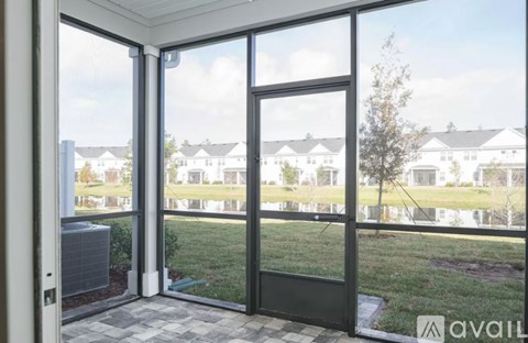 A view of a residential area through a sliding glass door.