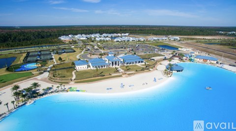 A large resort with a swimming pool and a beach.