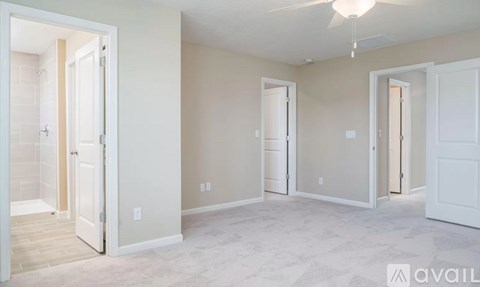 A room with white doors and a ceiling fan.