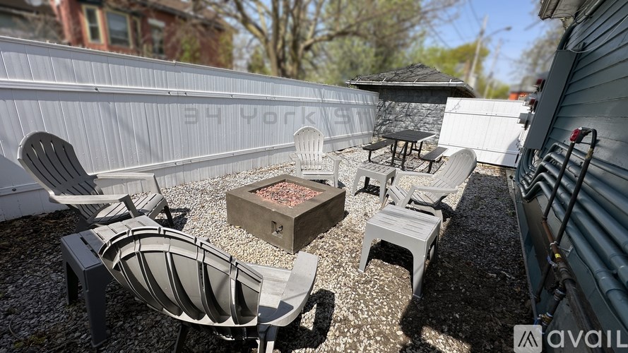 A patio area with a table, chairs, and a fire pit.