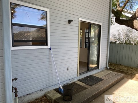 A white house with a window and a door.