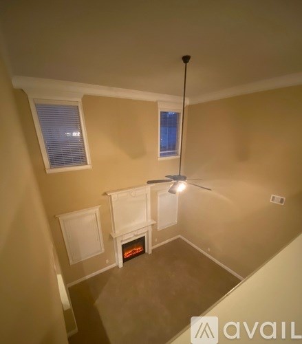 A room with a fireplace and a ceiling fan.
