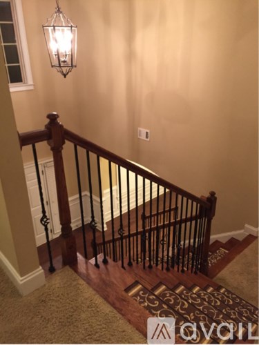 A staircase with a light hanging above it.