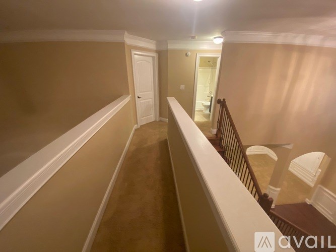 A hallway with a staircase leading to the second floor.