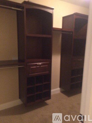 Two large wooden bookcases with shelves are in a room.