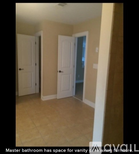 A master bathroom with space for vanity and laundry furniture.