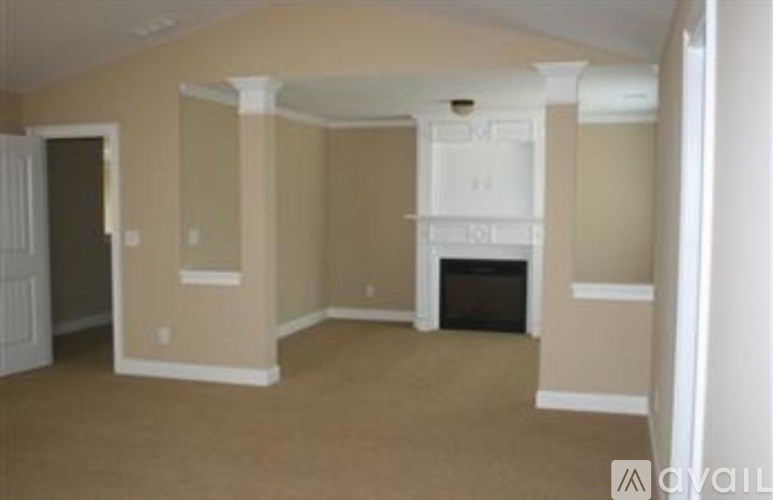 A living room with a fireplace and a white mantle.