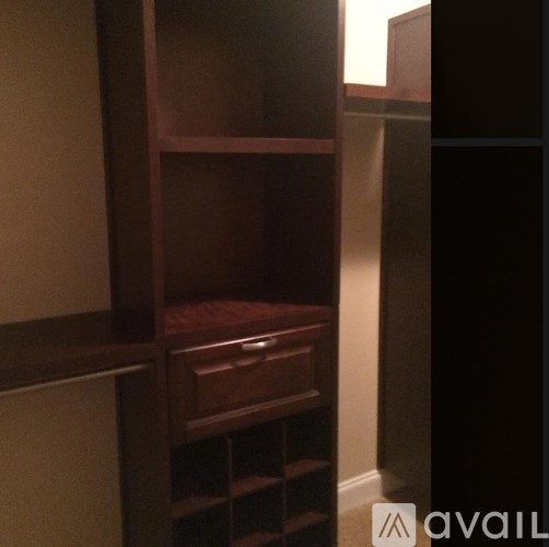 A wooden shelf with drawers is in a corner.