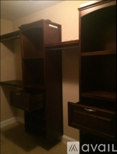 A brown wooden cabinet with drawers is in a corner.