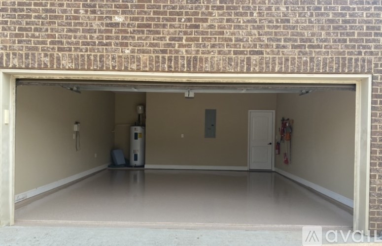 A garage with a brick wall and a white door.
