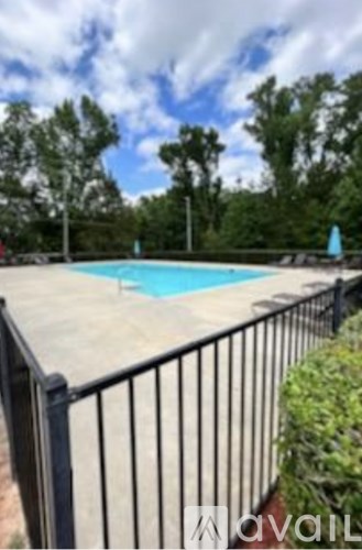 A pool surrounded by a black fence.