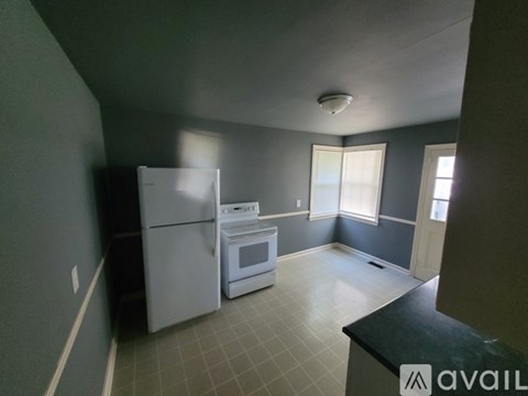 A kitchen with a white refrigerator and a white oven.