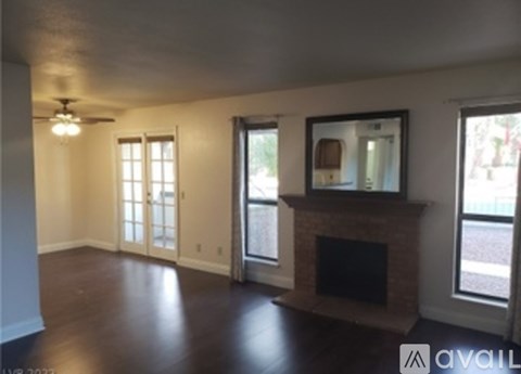 A living room with a fireplace and a painting on the wall.