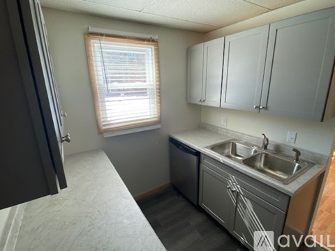 A kitchen with a window and a sink.
