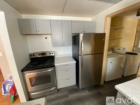 A kitchen with a stove, oven, and refrigerator.