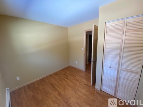 A room with wooden floors and a sliding door.