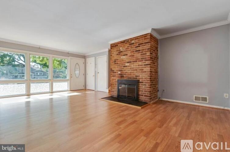 A room with a fireplace and wooden floors.