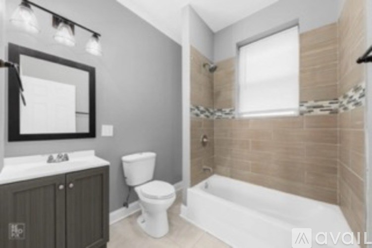 A bathroom with a toilet, sink, and bathtub.