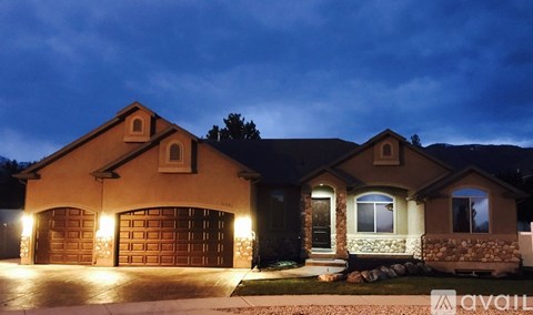 A house with a lit garage is available for sale.