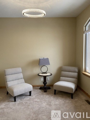 Two chairs and a table in a room.