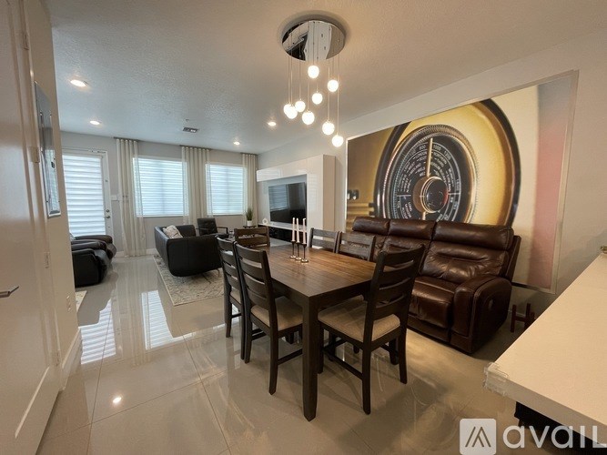 A dining room with a wooden table and chairs.