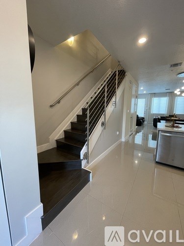 A staircase with a metal railing and wooden steps.