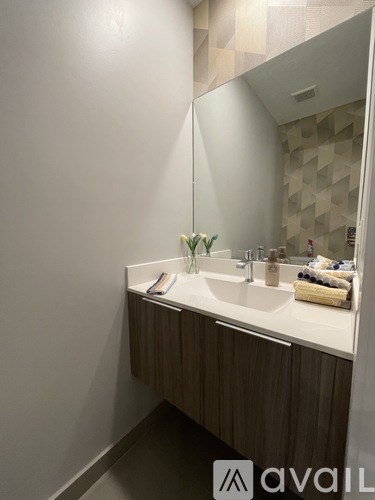 A bathroom with a sink and mirror.