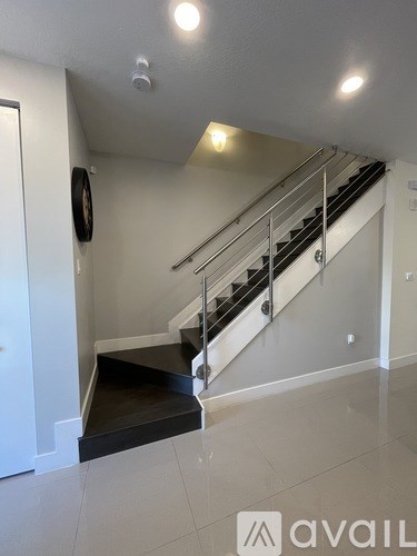 A staircase with a black tread and white risers.