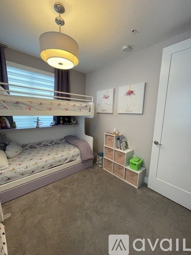 A bedroom with a bunk bed and a desk with storage boxes.