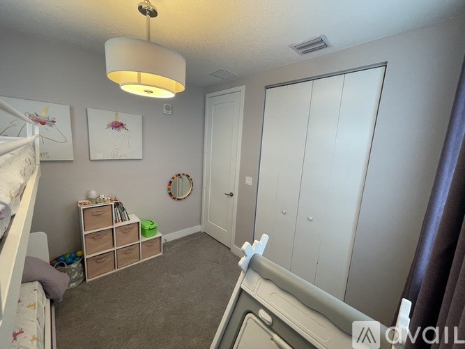 A bedroom with a bunk bed on the left and a wardrobe on the right.