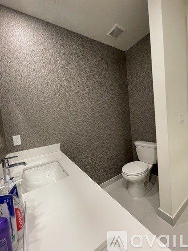 A bathroom with a toilet and sink.