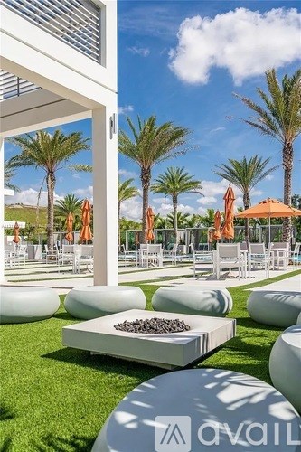 A white table with black stones on it is in the middle of a grassy area.