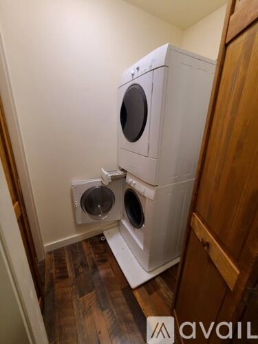 A white washing machine and dryer in a small laundry room.