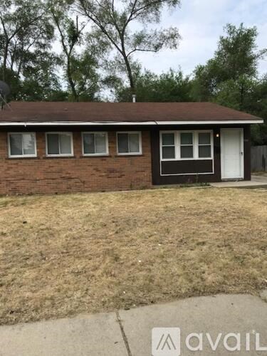 A small house with a brown roof and a black door.