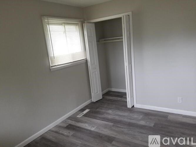 A room with a grey floor and a white door.