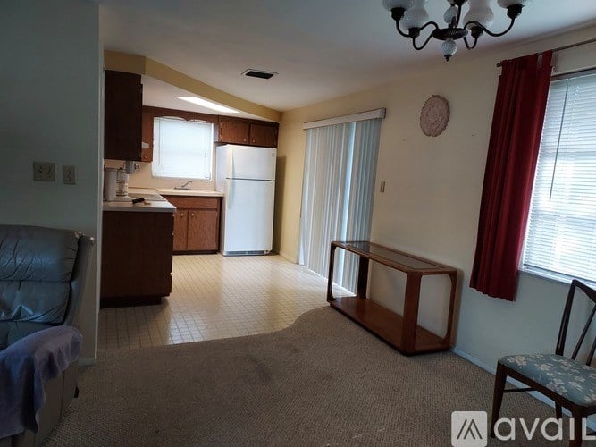 A living room with a couch, chair, and television set.