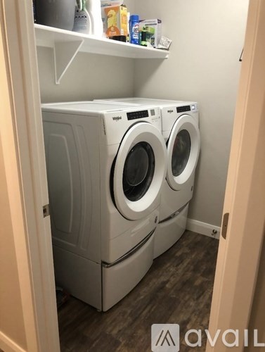 Two washing machines in a small laundry room.