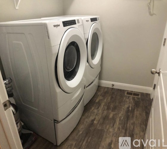 Two front loading washing machines in a small laundry room.