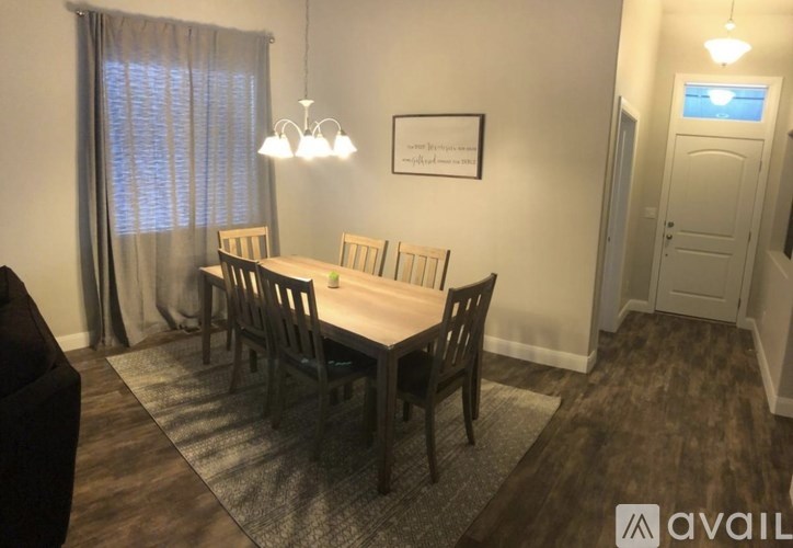 A dining room with a table and chairs.