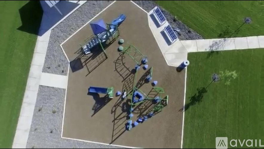 A playground with a swing set and a basketball court.