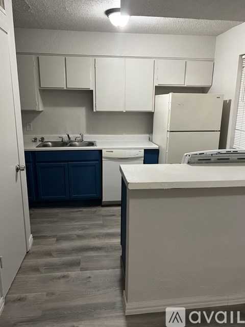 A kitchen with white cabinets and a blue drawer.