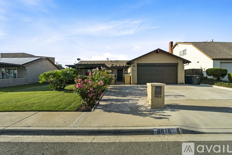 A house with a driveway and a mailbox in front.