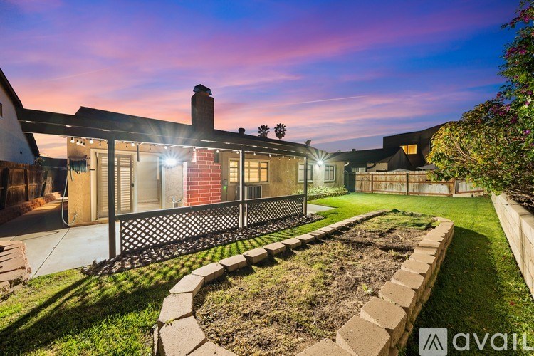 A house with a garden and a fence is shown in the image.