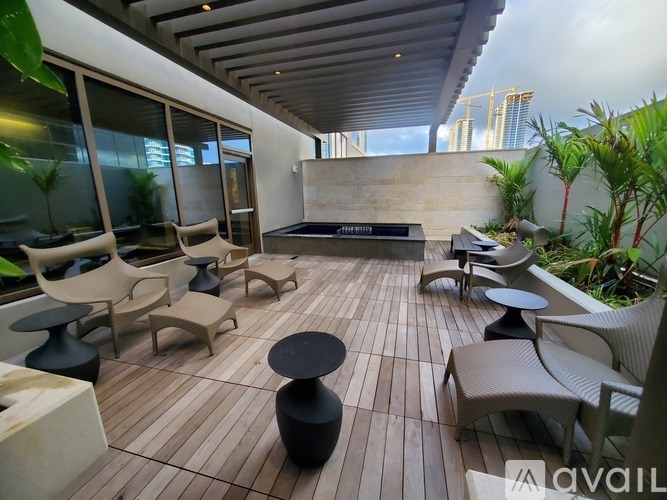 A patio with wooden flooring and furniture.