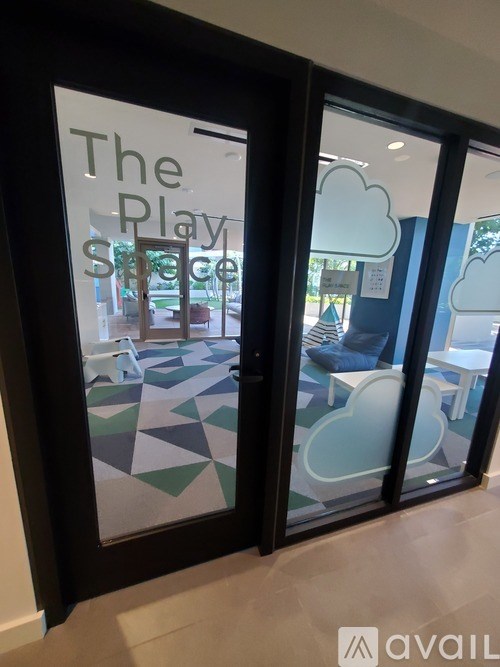 A glass door with a sign that says "The Play Space".