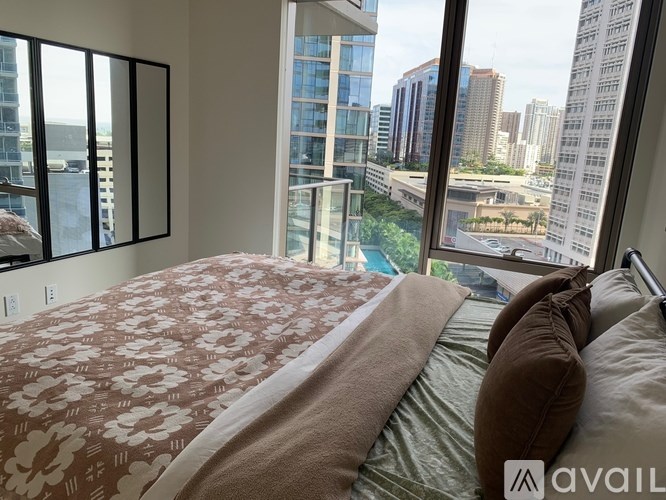 A bedroom with a large bed and a view of the city.