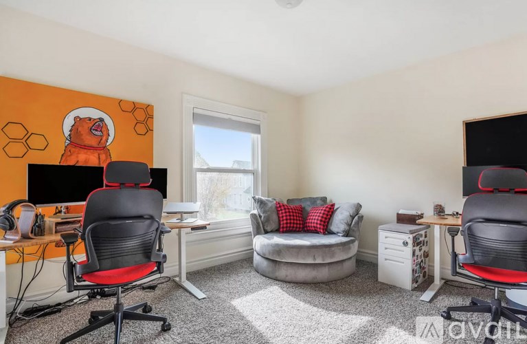 A room with a computer desk and a couch.